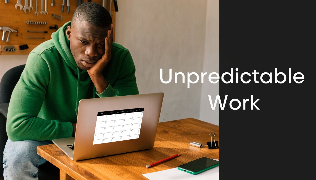 A stressed man wearing a green hoodie looks at his laptop screen displaying a blank calendar template.